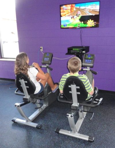 Kids compete with Exerbike GS interactive pedal game system