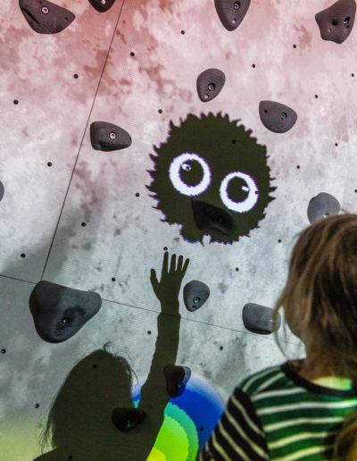 Young girl plays ValoClimb climbing wall with Shadowlings game