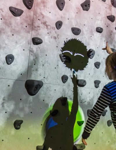 Young female plays ValoClimb climbing wall with Shadowlings game